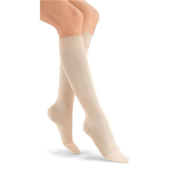 Pair of white JOBST soSoft Knee High Mild Compression Stockings (8-15 mmHg)